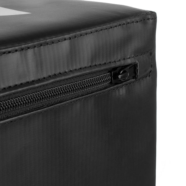 Close-up of the black zippered edge on a durable SMAI Plyometric Box - Pre-Assembled, often used for athlete safety gear. The zipper is slightly open, showcasing the structure and texture of the sturdy material. The fabric has a matte finish with visible stitching details.