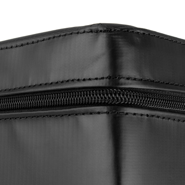 Close-up of a black zippered case corner, highlighting its durable stitching and texture. The material appears sleek and smooth, resembling the reinforced surface of the SMAI Plyometric Box - Pre-Assembled, with the zipper running horizontally across the image to enhance athlete safety.