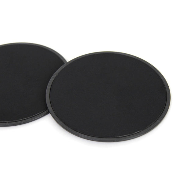 Two Ab Slide Discs by SMAI, sleek and round in black, overlap on a white background.