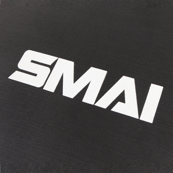 White letters spelling "SMAI" on a textured dark surface, reminiscent of fitness equipment like the SMAI Rebounder Mini Trampoline 50".