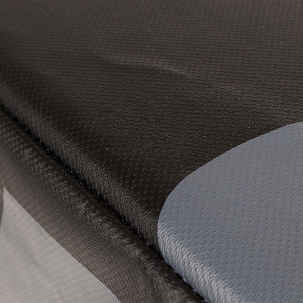 Close-up of a textured surface reminiscent of the SMAI Plyometric Box - WOD Pro, featuring black and gray materials. The black area has a fine mesh-like texture, while the gray part is smooth, and both sections are seamlessly joined.