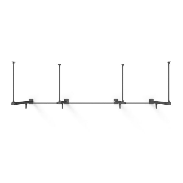 A minimalist black wall-mounted rig named the "Wall Mounted Rig - 2 Squat Cell with Bridge - X-Frame" by No Sync To Channel Engine features a modular design, with four rectangular brackets evenly spaced along the horizontal bar. This setup is perfect for supporting lighting or other fixtures and stands out elegantly against a white background.