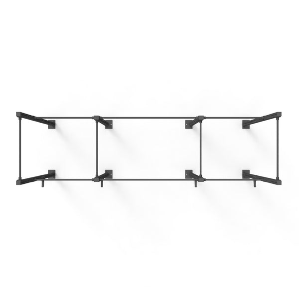 Overhead view of the Rig - 4 Squat Cell with Bridge by No Sync To Channel Engine, featuring a minimalist black metal frame crafted from steel tubing with four rectangular sections. This modular design is sleek and modern, ideal for shelving or support, set against a plain white background.