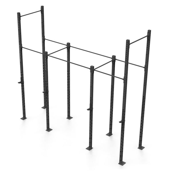 The Rig - 4 Squat Cell with Bridge, engineered by No Sync To Channel Engine, is constructed from durable steel tubing and includes numerous vertical metal supports alongside horizontal bars to create a solid frame. This commercial-grade equipment is intended for physical fitness and strength training exercises and is displayed against a plain white background.