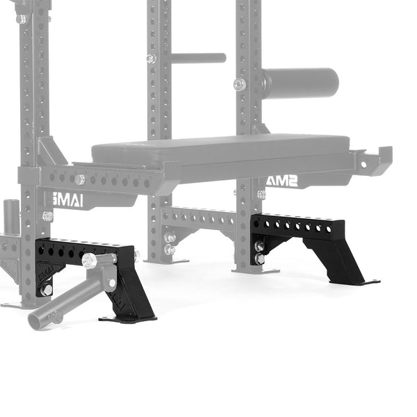 A gym bench accessory with SMAI's Rack Legs from the Vanta Series, which come in black. These stabilizing legs are integrated with a larger power rack system. The Vanta Series is constructed from metal and includes adjustable components to ensure safe bench press workouts.